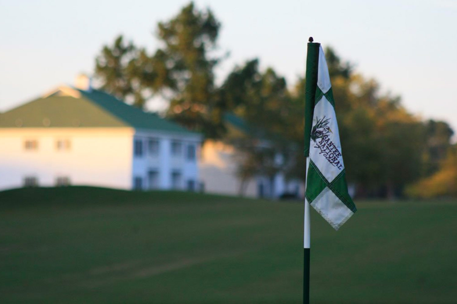 golf tee flag in foreground with villas in background